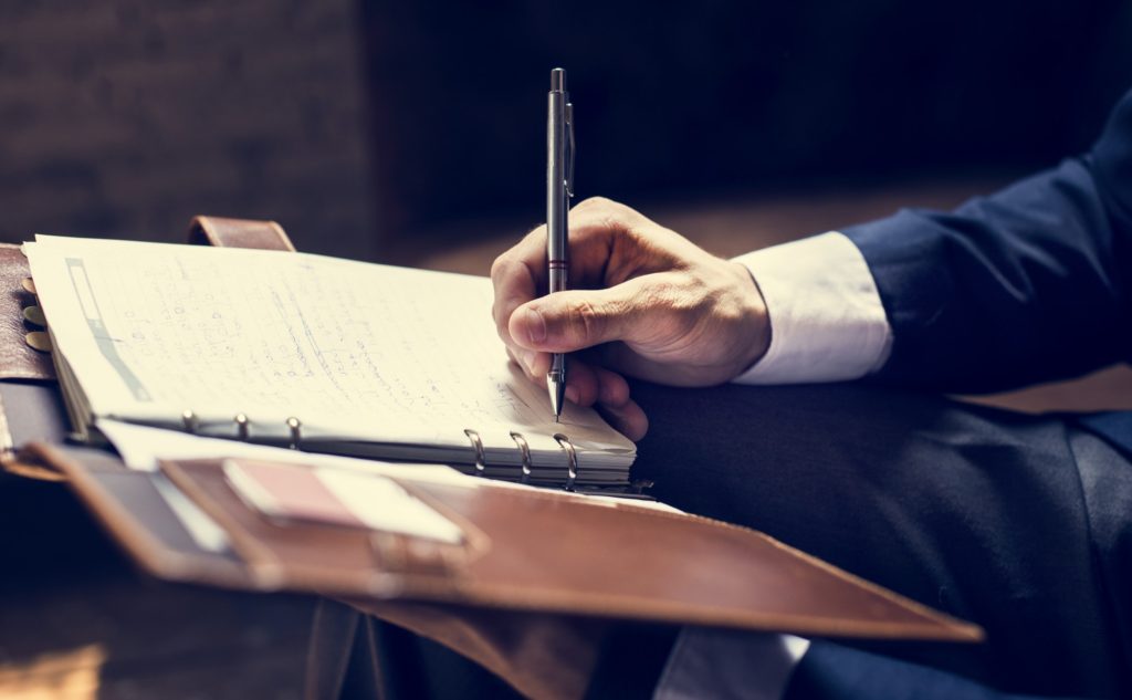 Businessman writing a note. SFI Forensics.